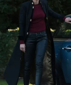 Women's long black coat with high stand-up collar, structured fit, elegant outerwear.