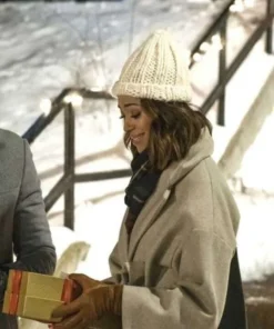 Close-up of Charity Jones in her Christmas Unwrapped coat. A chic wool blend outerwear piece with a wide lapel collar, perfect for a cozy winter look.