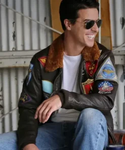 Tom Cruise wearing a top gun maverick jacket with aviator sunglasses, showcasing the stylish fit and detailed embroidery of this iconic bomber jacket.