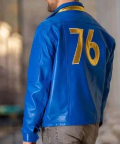 Back of a Fallout Vault Dweller 76 leather jacket, showing the large gold '76' logo on a blue jacket.
