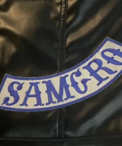 Close-up of the SAMCRO blue and white patch stitched onto a black leather sons of anarchy vests. soa vest