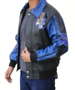 Side profile of a scooby doo bomber jacket showing blue leather sleeves with patches and a classic scooby doo varsity jacket silhouette.