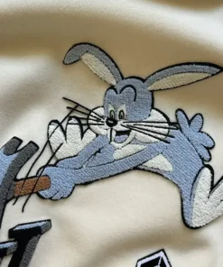 Bugs Bunny Louis Vuitton varsity jacket featuring LV logo embroidery and cartoon patches inspired by the Louis Vuitton FW22 varsity jacket collection.