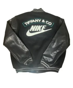 Full-body flat lay of a black and leather Tiffany and Co Nike jacket (varsity style). The back features 