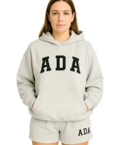 Front view of a woman in a light grey melange oversized hoodie with "ADA" printed in black collegiate lettering.