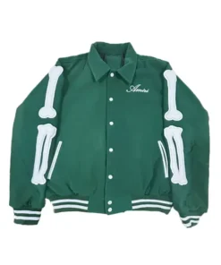 Front view of the green Amiri bomber jacket featuring white bone appliqués on the sleeves, the Amiri script logo embroidered on the chest, and striped ribbed cuffs. This men's designer bomber jacket is an iconic Amiri jacket for men style.