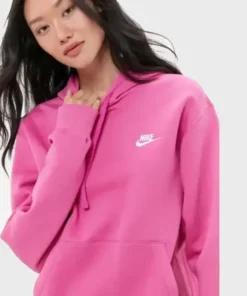 Close-up of a model wearing a bright hot pink Nike hoodie for women. Perfect ladies pink Nike hoodie style, showcasing the white Nike logo.