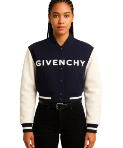 Front of a woman wearing a navy and cream cropped varsity jacket with 