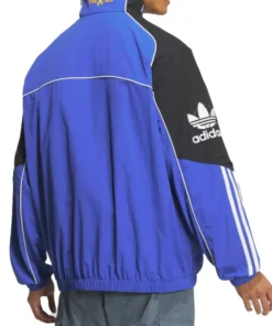 Back view of Adidas Adicolor Motorcore Woven Jacket in blue and black with bold white piping and Traxion branding on collar