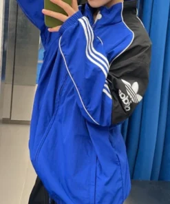 Adidas Motorcore track jacket featuring zip-up front, contrast sleeves, and sporty street-style graphics