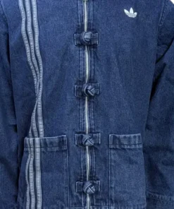 Close-up of the blue denim fabric and colorful embroidery on the Adidas jacket at America Jackets.