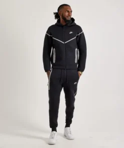 Front view of black Nike Tech reflective fleece tracksuit with white detailing and zip-up hoodie for men.