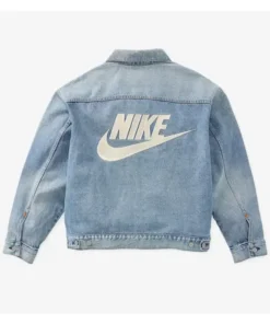 Blue denim jacket with large white Nike logo on the back.