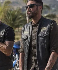 Mayans M.C Angel Reyes Leather Vest worn by Clayton Cardenas, front view with club patches and sunglasses.