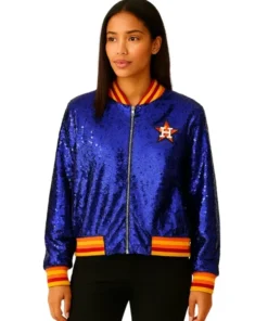 Full-length front view of a woman modeling a dazzling sequin astros jacket. The blue bomber jacket features the Houston Astros star logo on the chest and has red and yellow striped ribbed trim on the collar, waist, and cuffs, perfect for a women's astros jacket look.