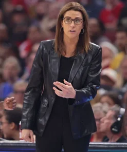 Stephanie White talking courtside in leather jacket.