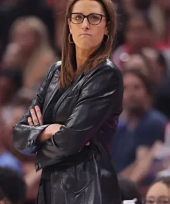 Stephanie White watching game with arms crossed.