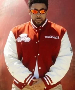 Man wearing Travis Scott x State Farm red and white varsity jacket, featuring embroidered patches and bold retro design.
