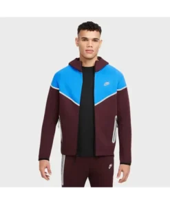 Front side of burgundy New Nike Tech Reflective Windrunner tracksuit with blue detailing and reflective zip pockets.