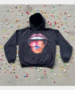 This black homesick x2c hoodie is laid flat on a textured surface, showcasing the signature artistic tongue design of homesick apparel.