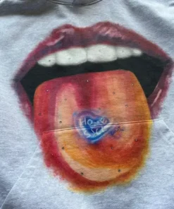 Detailed view of homesick apparel showing a tongue with a blue heart. This homesick x2c hoodie design highlights unique homesick clothing style.