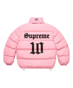 Full-frame back view of the pink Supreme Umbro Down Puffer Jacket with a mock neck (no hood). It has a large black 'Supreme' and '10' graphic printed on the back.