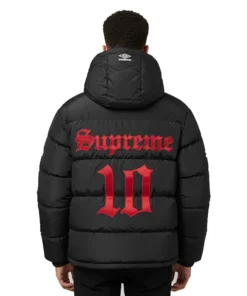 Back view of a model wearing the black Supreme Umbro Down Puffer Jacket with a hood. It has a large red 'Supreme' and '10' graphic printed on the back.