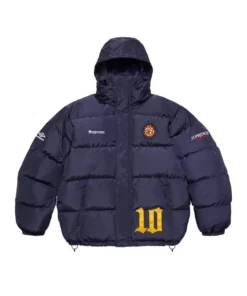 Full-frame front view of the navy blue Supreme Umbro Down Puffer Jacket with a hood. It features 'Supreme' on the chest, a patch emblem, an Umbro logo on the sleeve, and a large yellow '10' graphic.
