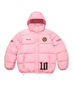 Full-frame front view of the pink Supreme Umbro Down Puffer Jacket with a hood. It features 'Supreme' on the chest, a patch emblem, an Umbro logo on the sleeve, and a large black '10' graphic.
