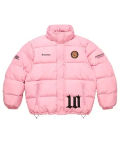 Full-frame front view of the pink Supreme Umbro Down Puffer Jacket with a mock neck (no hood). It features 'Supreme' on the chest, a patch emblem, an Umbro logo on the sleeve, and a large black '10' graphic.