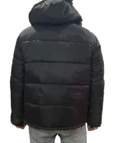 Back view of a man wearing a black Polo puffer jacket with hood, showcasing the quilted back and insulation.