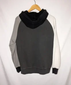 Back view of a black teddy fresh color block hoodie on a hanger, featuring black, gray, and white panels.