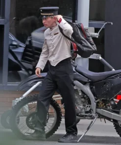 Barry Keoghan in Crime 101 bellhop uniform featuring gold buttons and a formal hotel-style look.