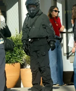 Crime 101 Barry Keoghan black pullover hoodie paired with tactical black pants and biker gloves on set.