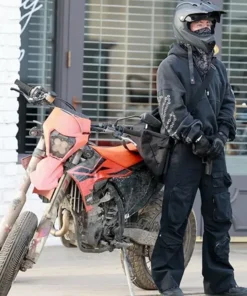 Barry Keoghan spotted in Crime 101 black pullover hoodie while standing beside an orange motorbike during shoot.