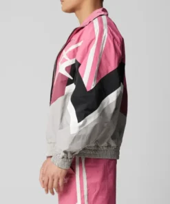 Barry Keoghan pink biker hybrid jacket side pose from Crime 101 highlighting black, white, and pink color blocks.