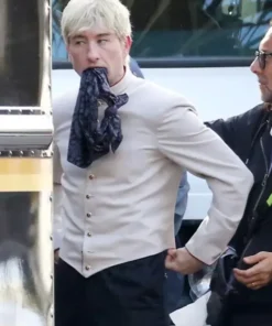 Close-up of Barry Keoghan wearing the Crime 101 costume jacket as a bellhop character from the film.