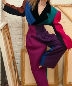 Zendaya striking a fashionable pose in a Marc Jacobs color block zoot suit at a Vanity Fair event.