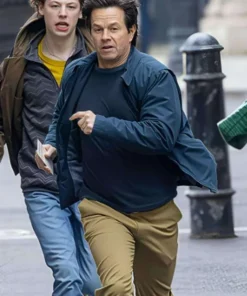 Mark Wahlberg in The Family Plan 2 blue jacket, looking stylish while walking in the street