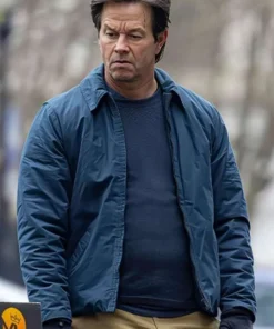 Mark Wahlberg wearing a casual blue jacket from The Family Plan 2, looking confident