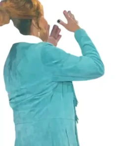 Reba McEntire on The Voice S28 stage in her blue fringe coat, a back view of the vibrant teal jacket.