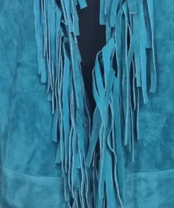 Close-up of the flowing fringe detail on Reba McEntire's turquoise fringe jacket The Voice, S28 outfit.