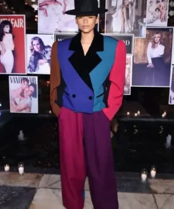 Zendaya wearing a Marc Jacobs color block zoot suit in bold colors at a Vanity Fair celebration.