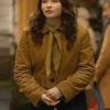 Zoe Colletti wearing a corduroy jacket with a green tie, captured while walking on the street in The Family Plan 2