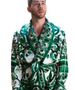 Front view of Nick Jonas wearing the green robe featured in A Very Jonas Christmas 2025. The luxurious patterned Nick Jonas Green Robe is tied at the waist. Buy Nick Jonas Green Robe.
