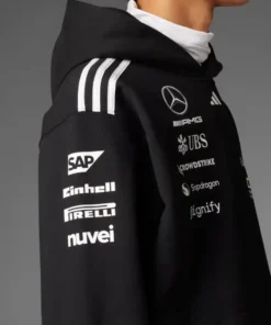 Side close-up of the Adidas Mercedes AMG Petronas F1 Team hoodie; showcasing sleeve sponsors like SAP, Pirelli, and nuvei.