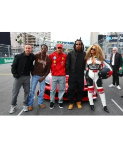 Beyoncé poses with Lewis Hamilton in a Louis vuitton Las Vegas F1 racer style track suit.