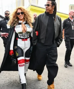 Beyoncé walks in a long coat over her Louis vuitton Las Vegas Formula 1 Grand Prix track suit.