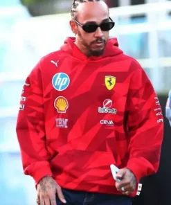 A candid shot of the driver wearing the Lewis Hamilton F1 Las Vegas race hoodie, featuring a vibrant red colorway and sponsor logos perfect for the Las Vegas race weekend.