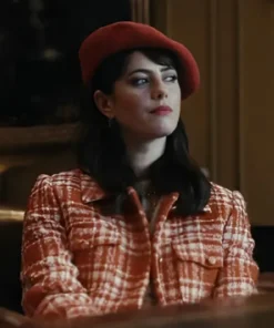 Kaya Scodelario as Susie Glass in her striking red and white plaid coat from Kaya Scodelario Plaid Coat series, worn with a red beret.